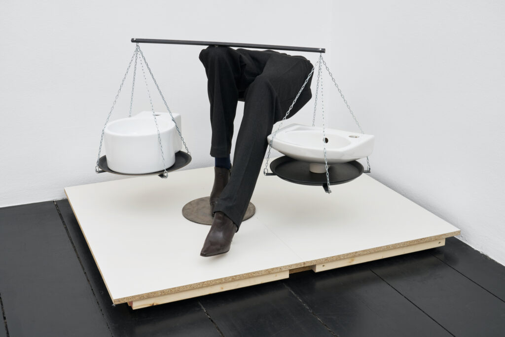 Morag Keil, Client (detail), 2024. Installation with desk, chair, laptop, mouse, keyboard, artist's website, platform, mannequin legs, sinks, chain, trays, obs boards, dimensions variable. Courtesy the artist and Galerie Isabella Bortolozzi, Berlin / Photo © Graysc