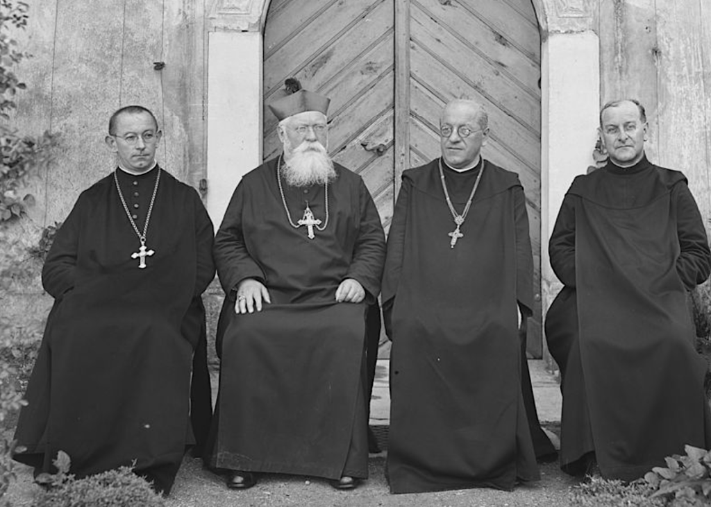 Gruppenfoto im Klostergarten Mariastein anlässlich des Trostfests im Juli 1931 1931-07-01/1931-07-31, Kloster Mariastein V.l.n.r. Abt von Engelberg Leodegar Hunkeler, Erzbischof von Bukarest Raymond Netzhammer, Abt Augustin Borer, Pater Willibald Beerli