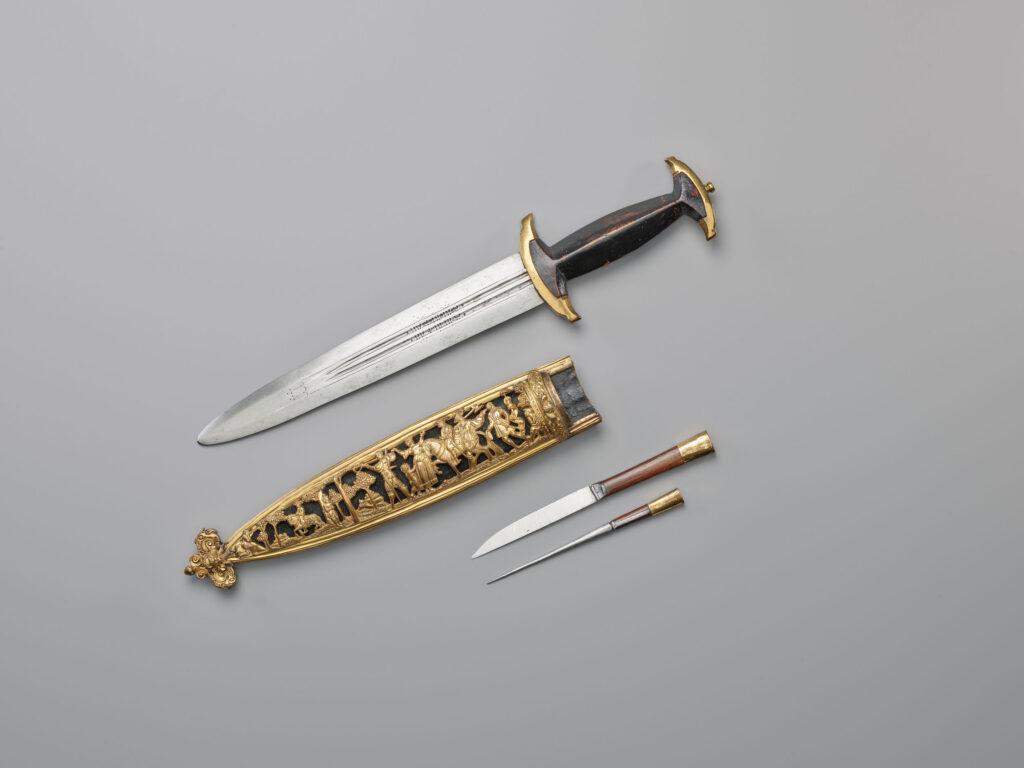 Schweizerdolch Die Geschichte von Wilhelm Tell schmückt bereits im 16. Jahrhundert auch die Scheiden der Schweizerdolche. Schweizerdolch mit Scheide, Messer und Pfriem, um 1570 © Schweizerisches Nationalmuseum