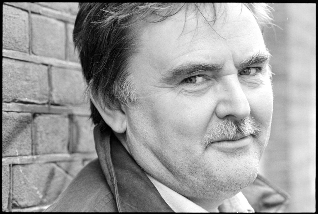 Glen Baxter, 1992 - Foto: Noord-Hollands Archief, collectie Fotopersbureau De Boer, NL-HlmNHA_1478_36324K00_04, https://noord-hollandsarchief.nl/beelden/beeldbankdeboer/?mode=gallery&view=horizontal&rows=45&page=1&fq%5B%5D=search_s_metadata_id:%22L15591%22&sort=random%7B1775253320235%7D%20asc&filterAction - Creative Commons CC0 1.0 Universal Public Domain Dedication - Datei: https://commons.wikimedia.org/wiki/File:Glen_Baxter,_tekenaar,_1992_-_04.jpg